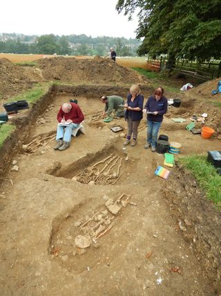 Archeologists and volunteers take notes during the excavation of the chapel and cemetery.