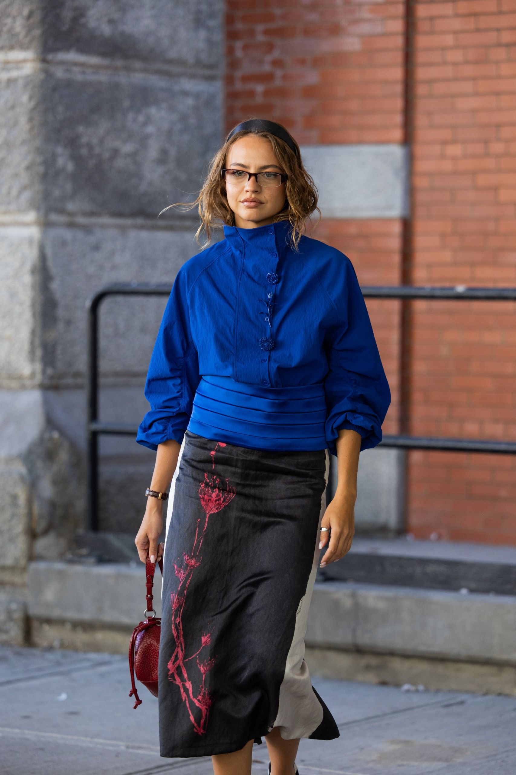 Woman in a cobalt blue jacket and a black skirt