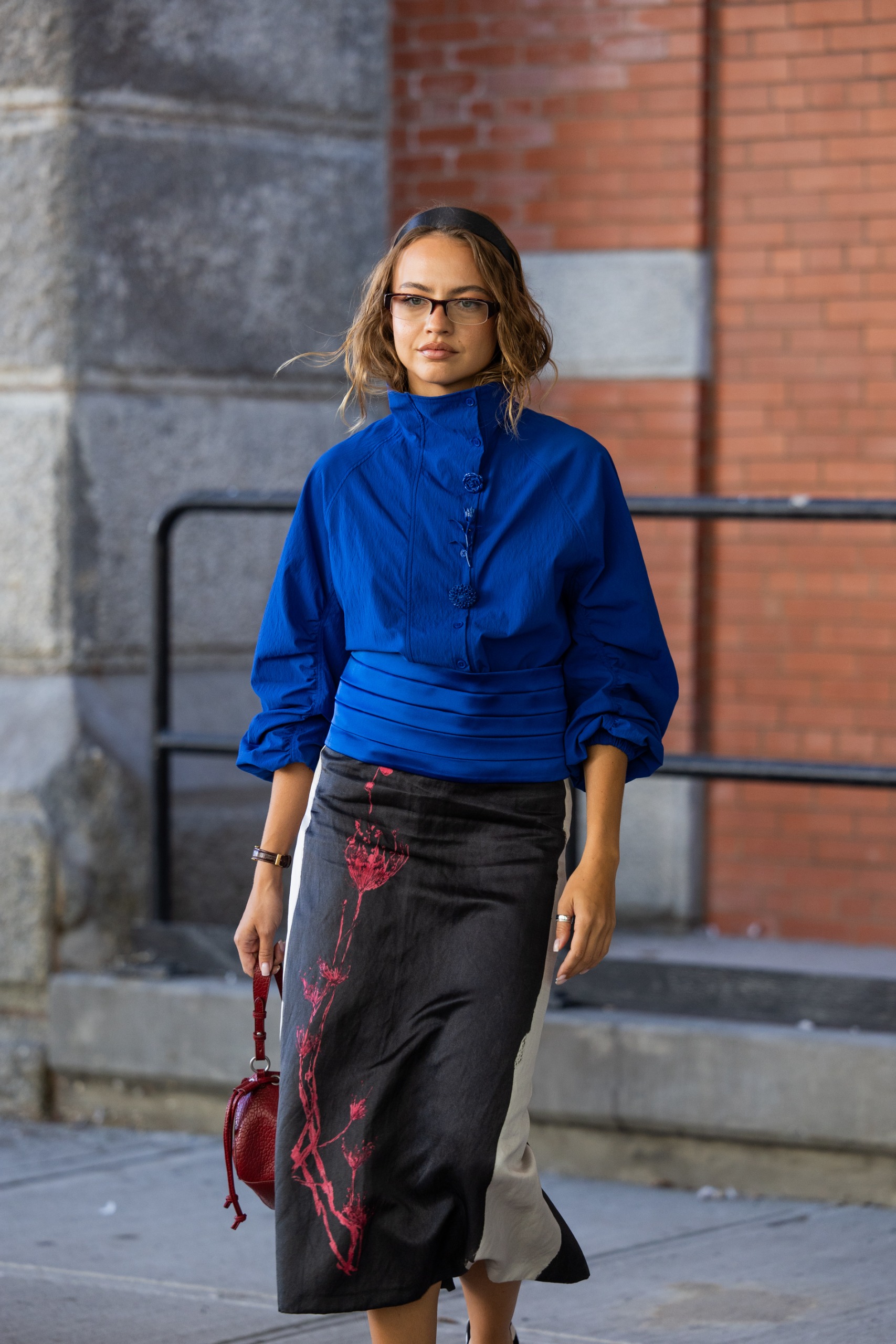 Woman in a cobalt blue jacket and a black skirt