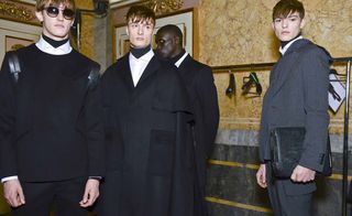 Group of models stood in black jackets