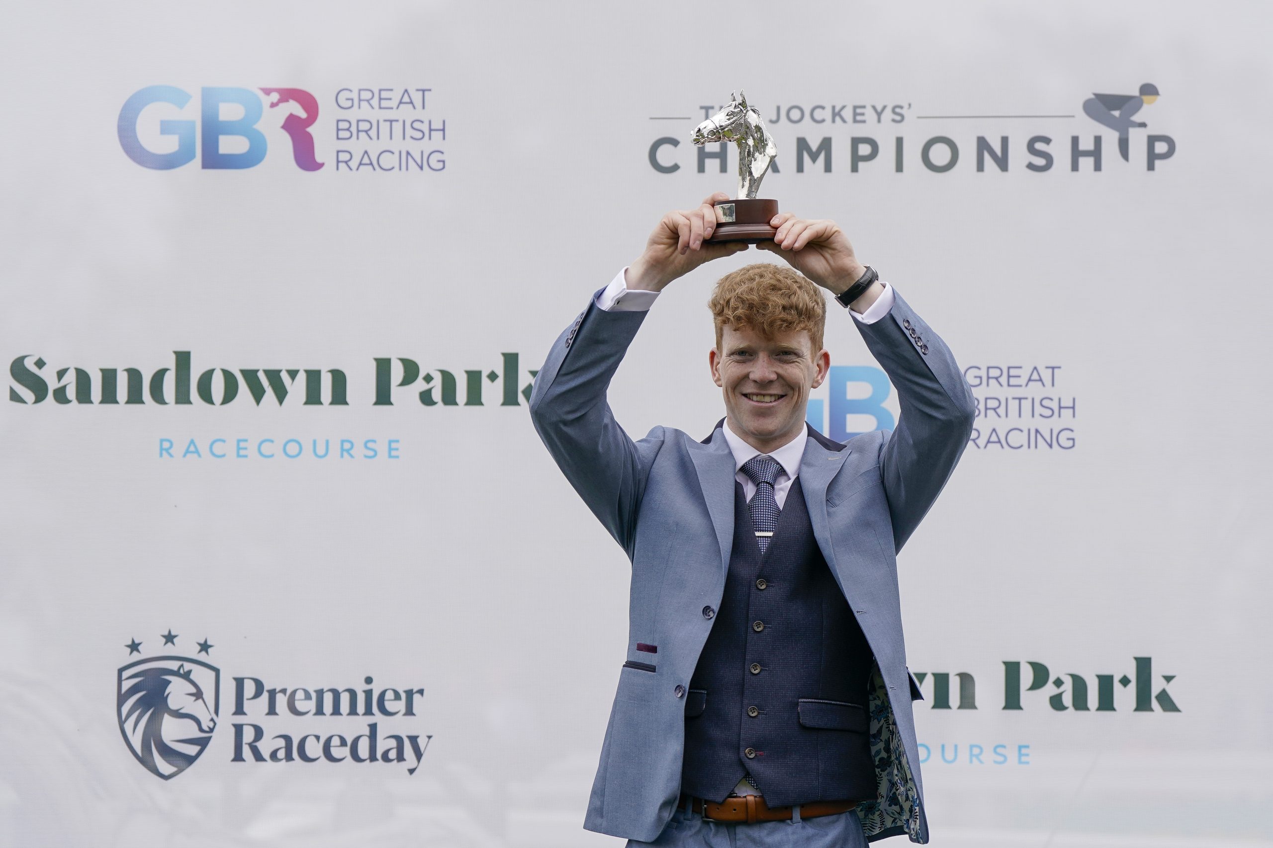 Patrick Wadge lifs the trophy as the new champion conditional jockey.