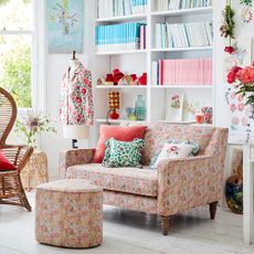 Floral snuggler sofa in white living room