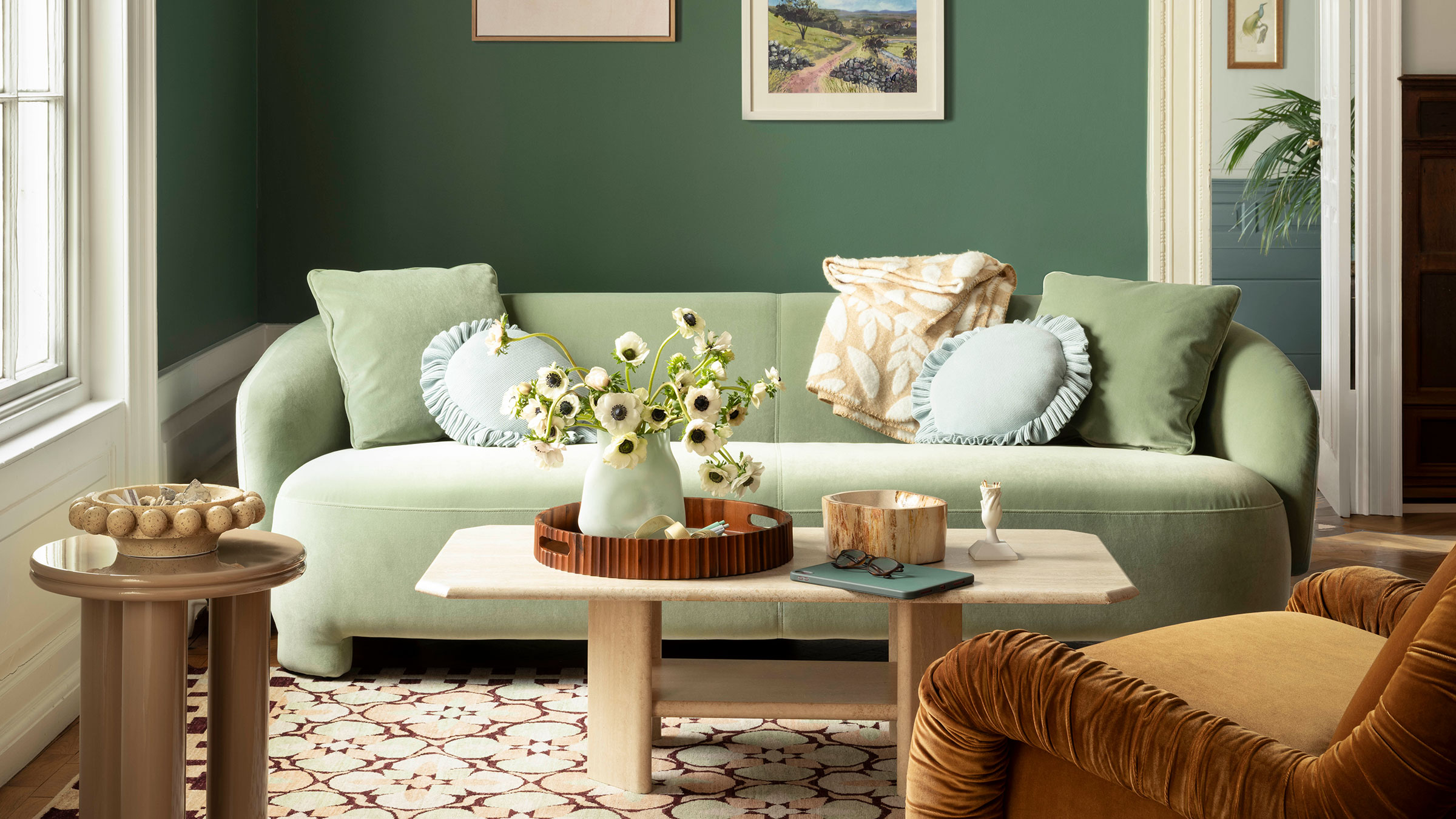 Living room painted in Benjamin Moore Webster Green with a pale green sofa