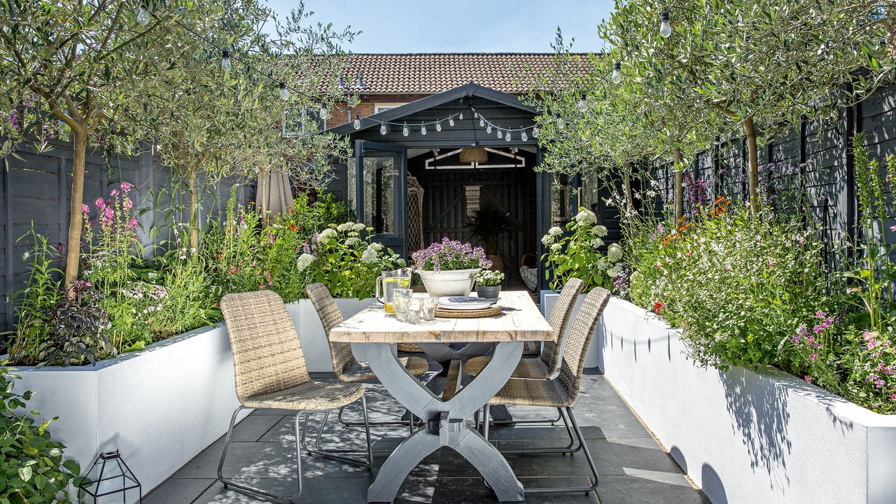 Shed with outdoor table and raised flower beds