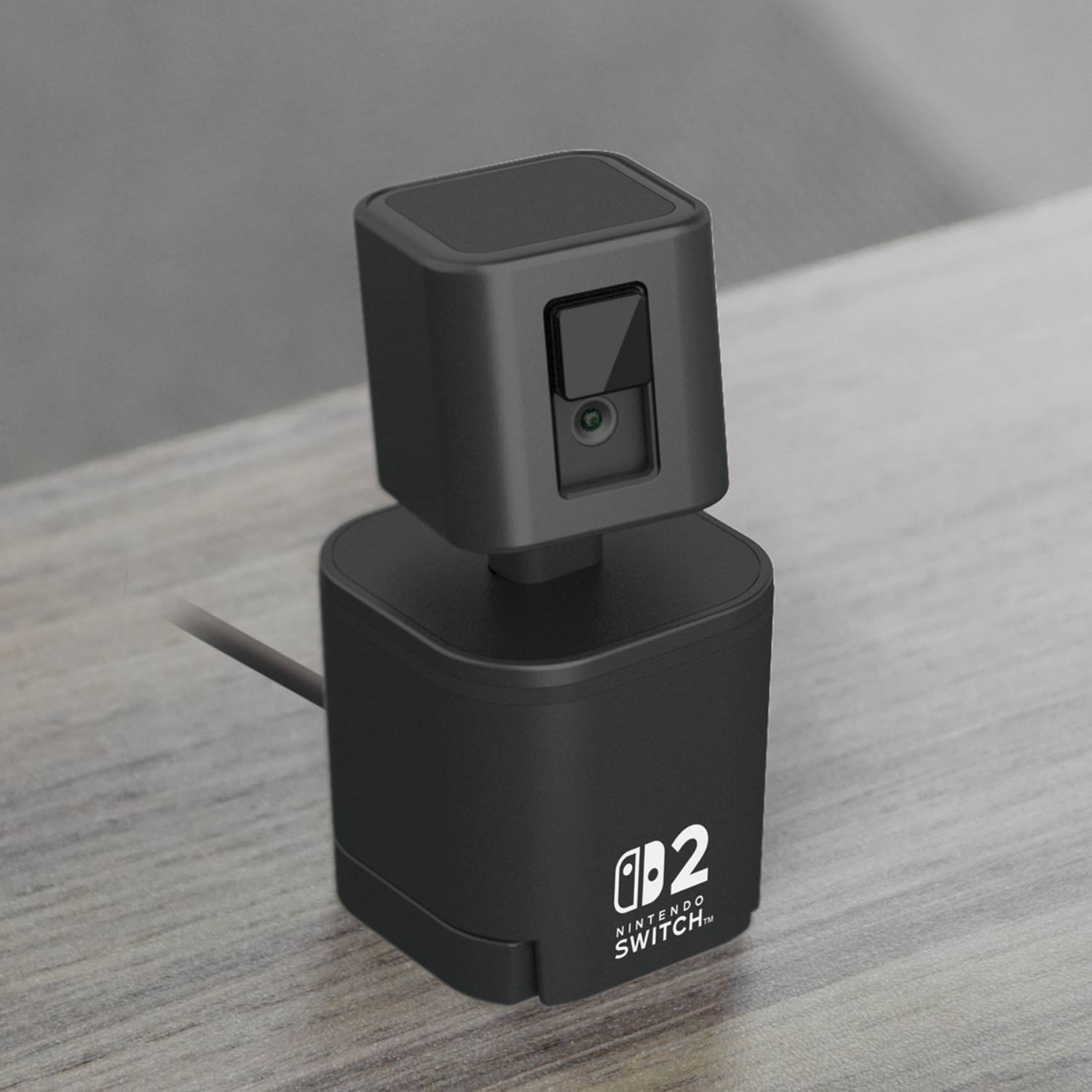 Official promo image of the Hori USB Nintendo Switch 2 camera sitting on a wooden desk.