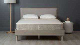 Best organic mattress: Photo of the Birch Natural mattress on a beige bedframe placed in a grey bedroom