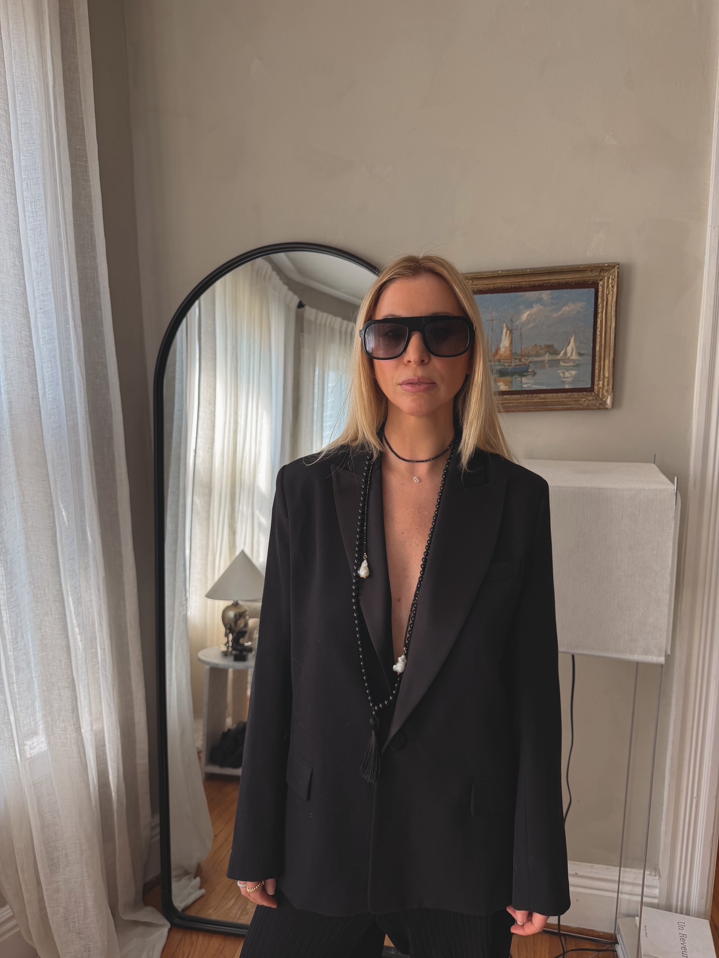 Kerry Pieri wears an all-black look featuring a statement necklace
