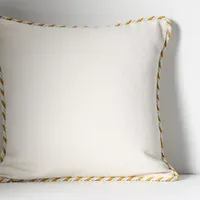 Kayla Piped Cushion in white: was £68 now £54 | Anthropologie (Save £14)