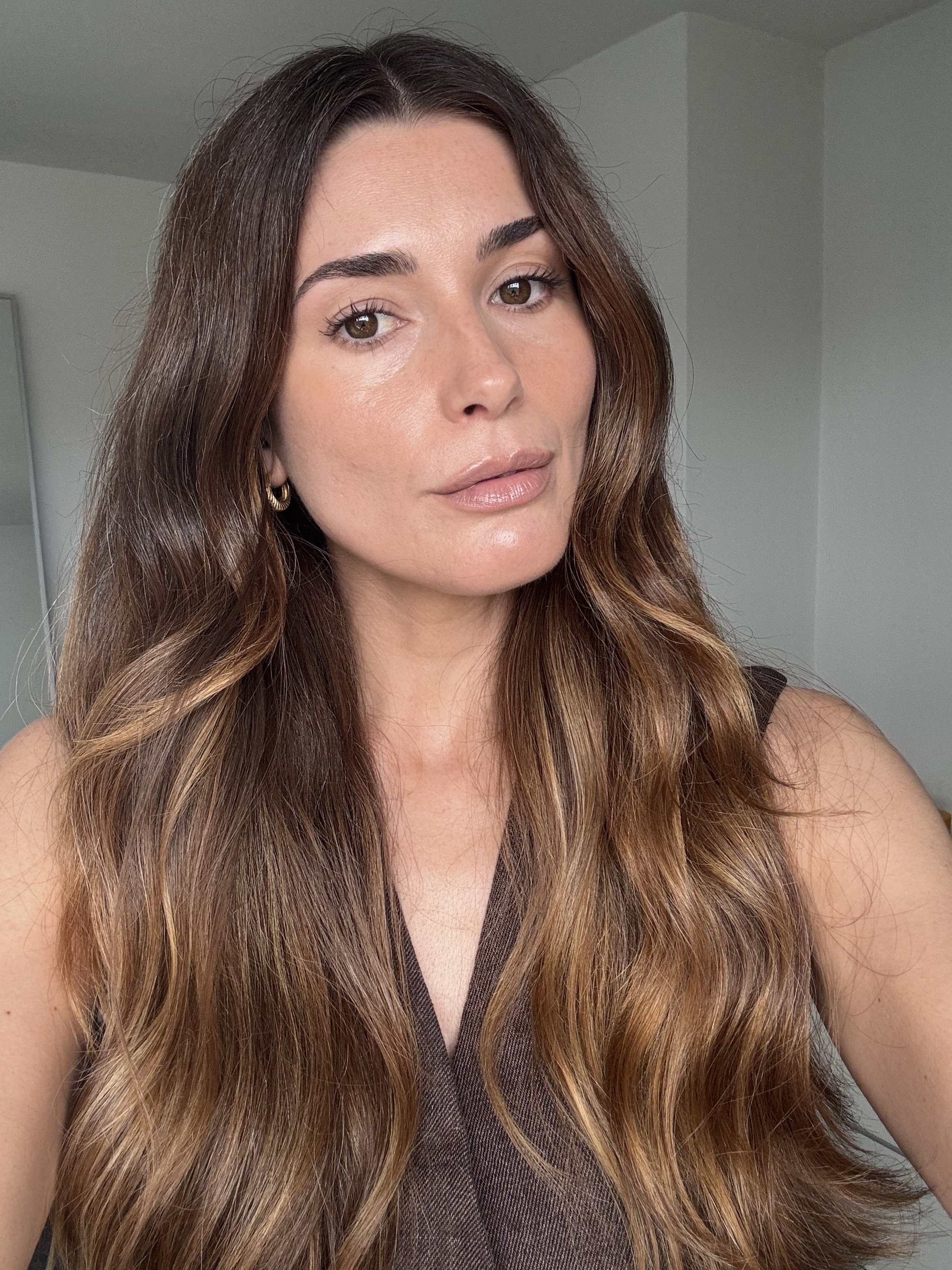 A selfie of beauty editor Eleanor Vousden wearing the Rhode Pocket Bronze in shade Sip