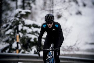 A cyclist riding in cold weather