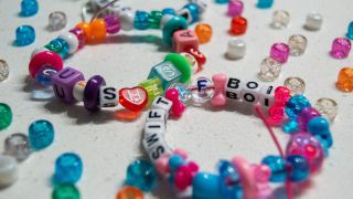 Friendship bracelets that say "Cuz She's Dead" and "Swift AF Boi."