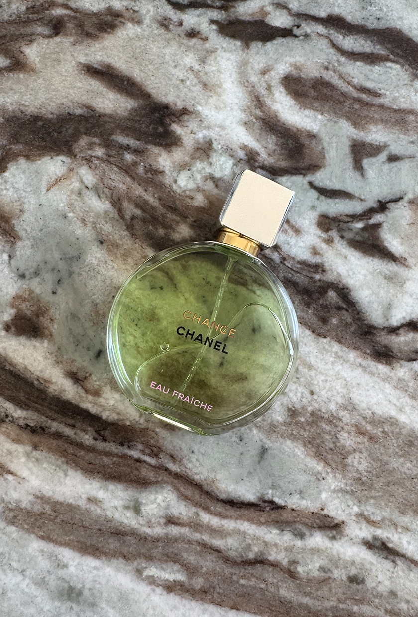 A bottle of Chanel Chance Eau Fraiche on a marble table