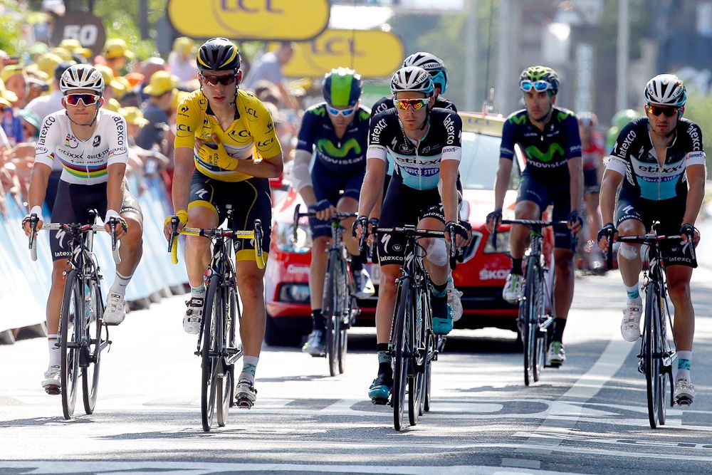 Tony Martin finishes the stage surrounded by teammates.