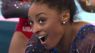 Simone Biles reacts to winning gold in the all-around competition at the Paris Olympics 2024.