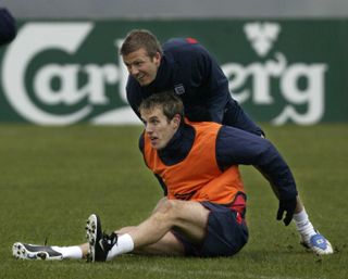 David Beckham (top) with Phil Neville are former team-mates with England and Manchester United