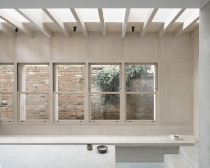 View from extension looking out to the side at Concrete Plinth House by DGN studio
