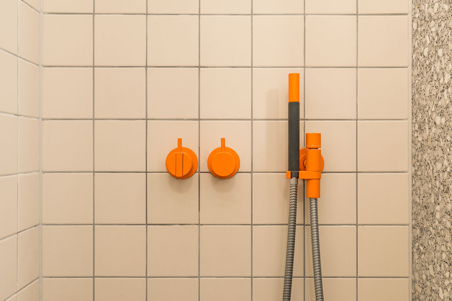 Tiling in the bathroom with orange taps