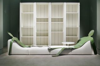 White shelving and seating with green cut-outs of people designed by Pierre Paulin