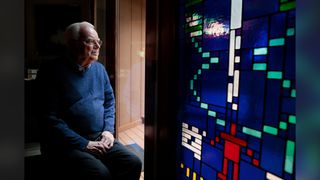 Frank Drake, the founder of SETI , sits next to a stained glass window of the Arecibo Message at his home in Aptos, California in 2015.