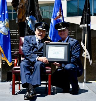 Space Force Lt. Gen. Michael Guetlein, Space Systems commander (at right) presents the Honorary Guardian certificate to retired Air Force Brig. Gen. Buzz Aldrin during Aldrin's promotion ceremony at Space Systems Command in Los Angeles on May 5, 2023.