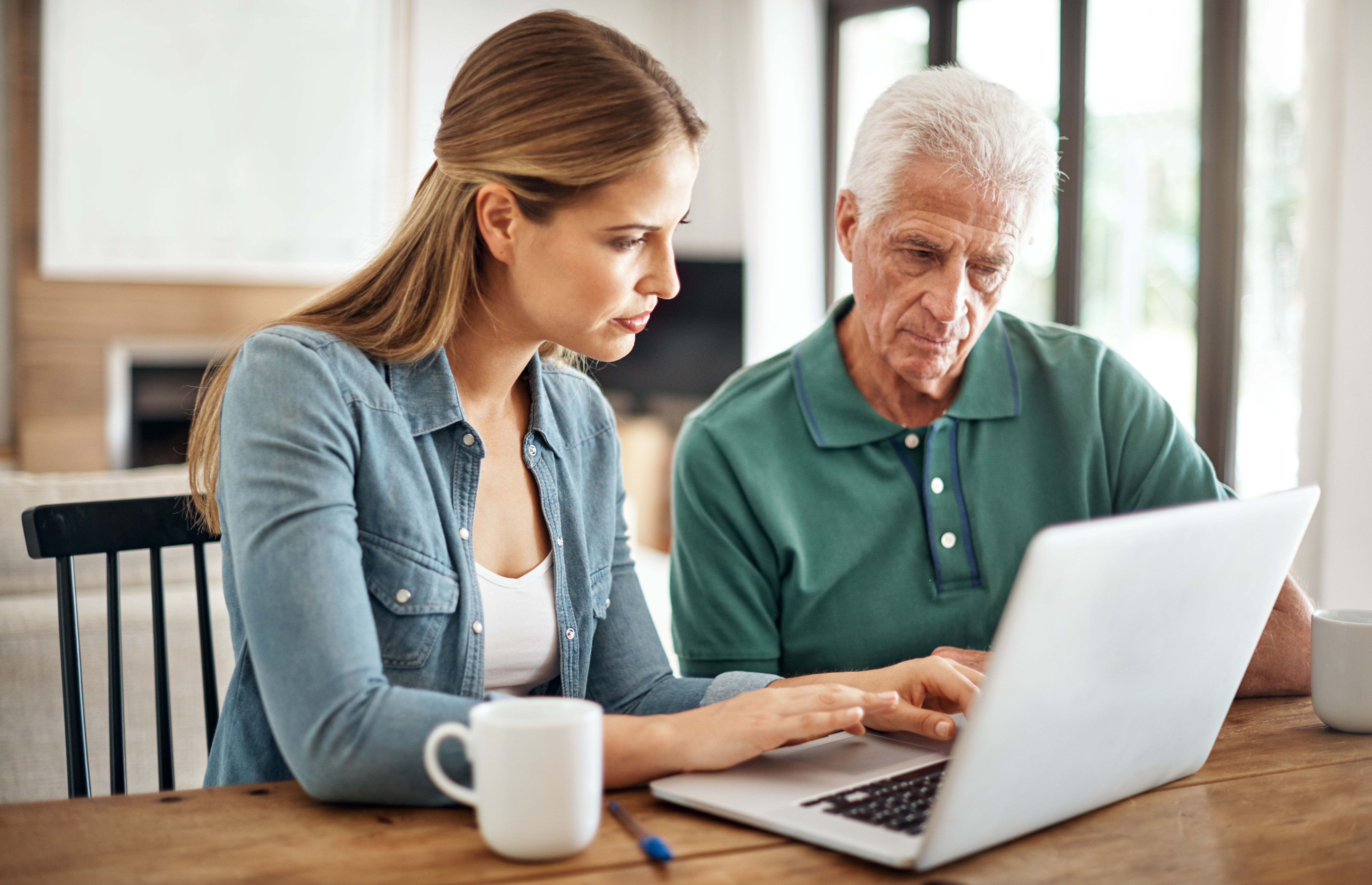 Cropped shot of a senior man going over his finances with the help of his daughter