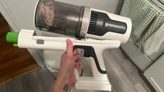 vacuuming oats with the greenworks cordless stick vacuum
