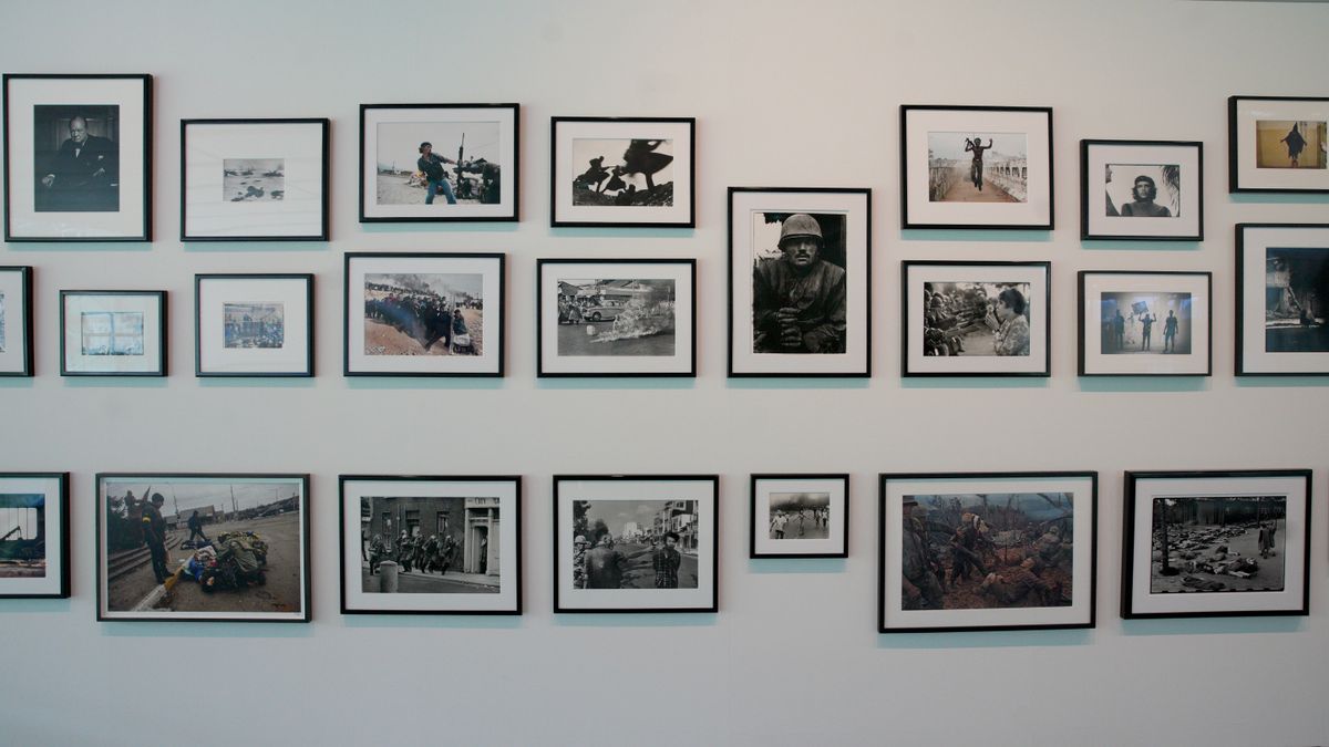 A section of the &#039;main wall&#039; displaying iconic photojournalism photos at The Camera Never Lies exhibition at the Sainsbury Centre in Norwich, England