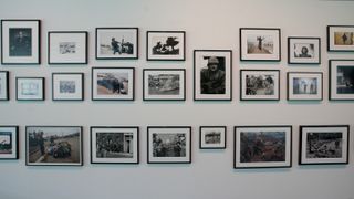 A section of the 'main wall' displaying iconic photojournalism photos at The Camera Never Lies exhibition at the Sainsbury Centre in Norwich, England