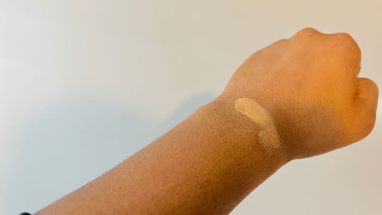 Glossier Stretch Concealer color swatch on a person's wrist for the best drugstore concealers.