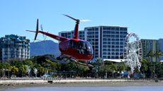 A helicopter takes off on a sightseeing trip in Cairns, Australia. 