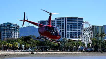 A helicopter takes off on a sightseeing trip in Cairns, Australia.