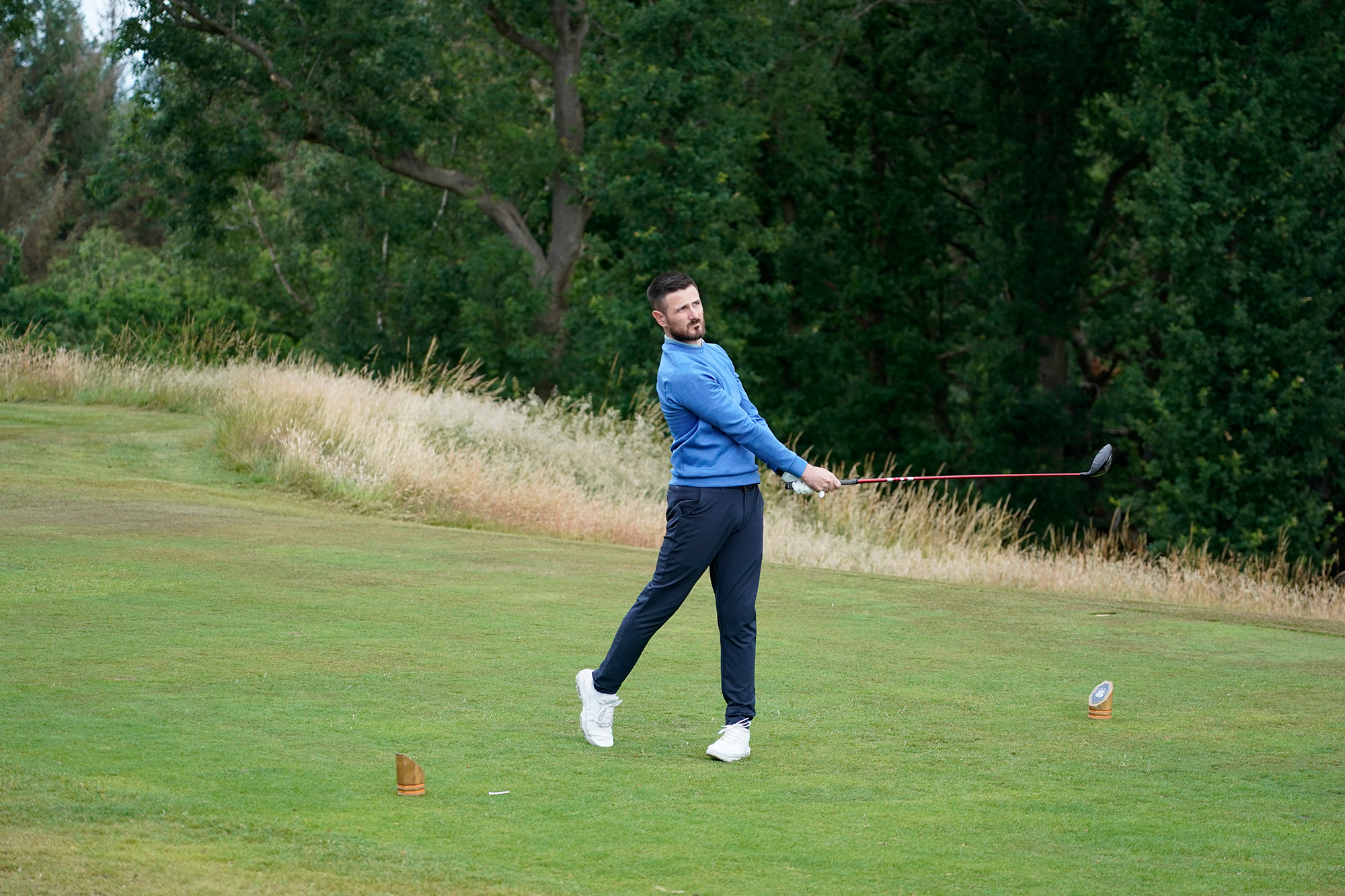 Baz Plummer hitting a driver off the tee at Sand Moor Golf Club