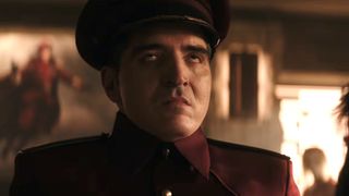 M. Bison with eyes rolled back in head after branding Chun Li in Street Fighter
