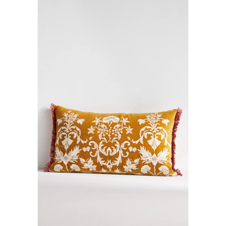 yellow throw pillow embroidered with florals