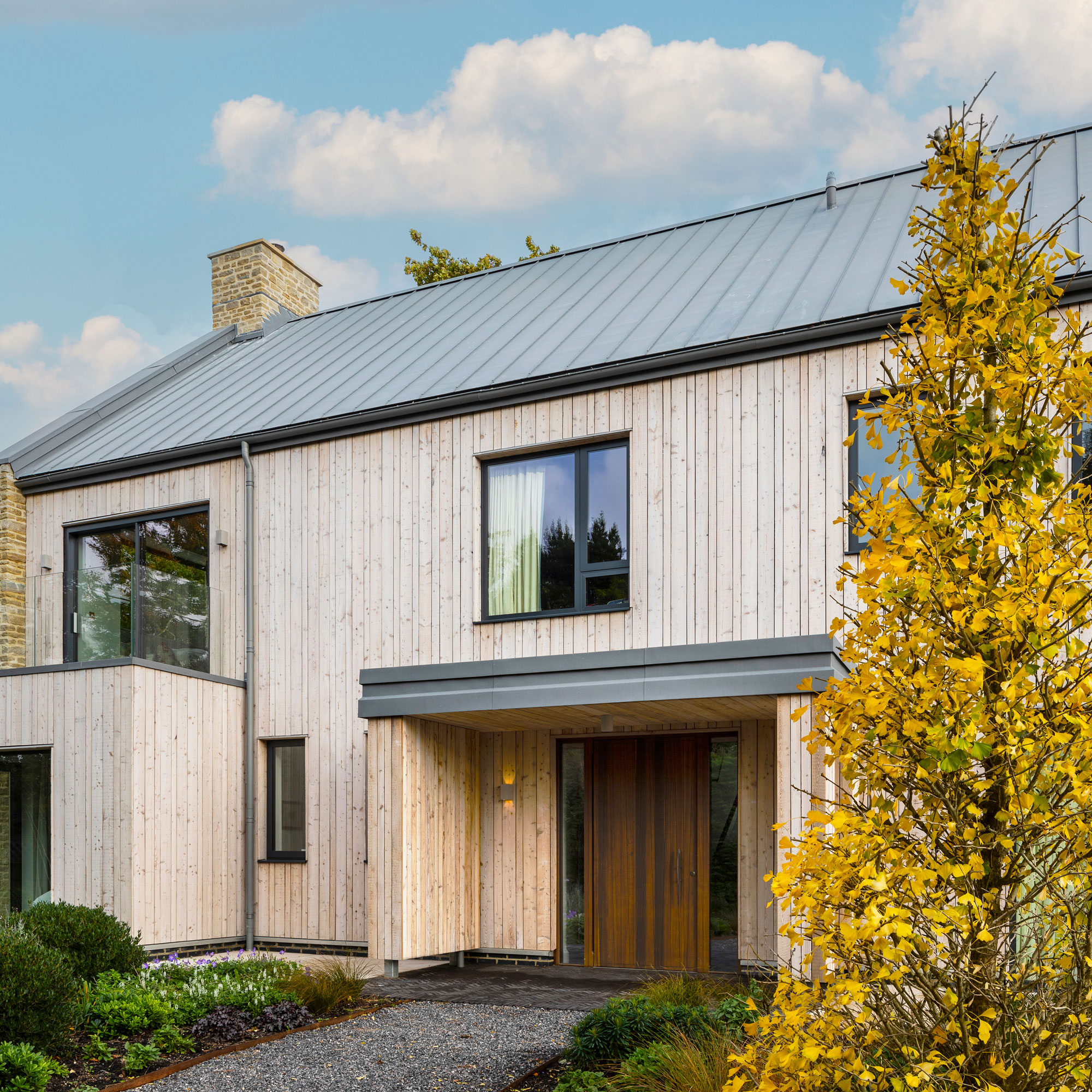 modern timber clad house with contemporary flat roof porch