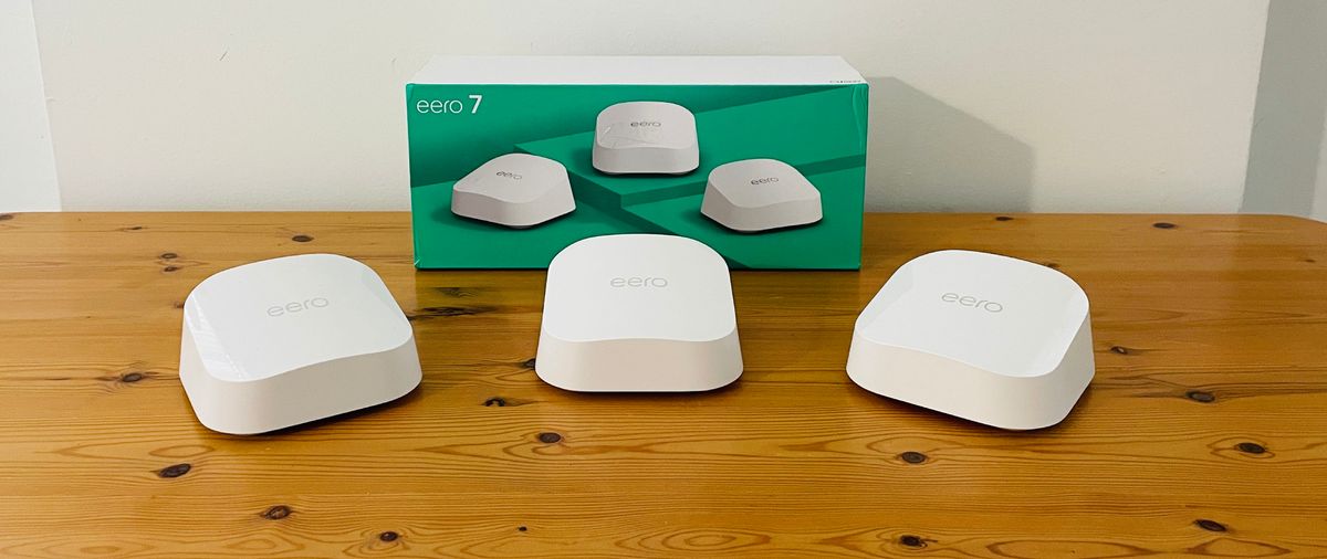 Eero 7 mesh Wi-Fi system on a wooden table