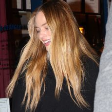 Margot Robbie was seen enjoying a day out with friends while spending time in Paris. She wore Chanel jeans and carried a Hermes bag as the group strolled through the city together.