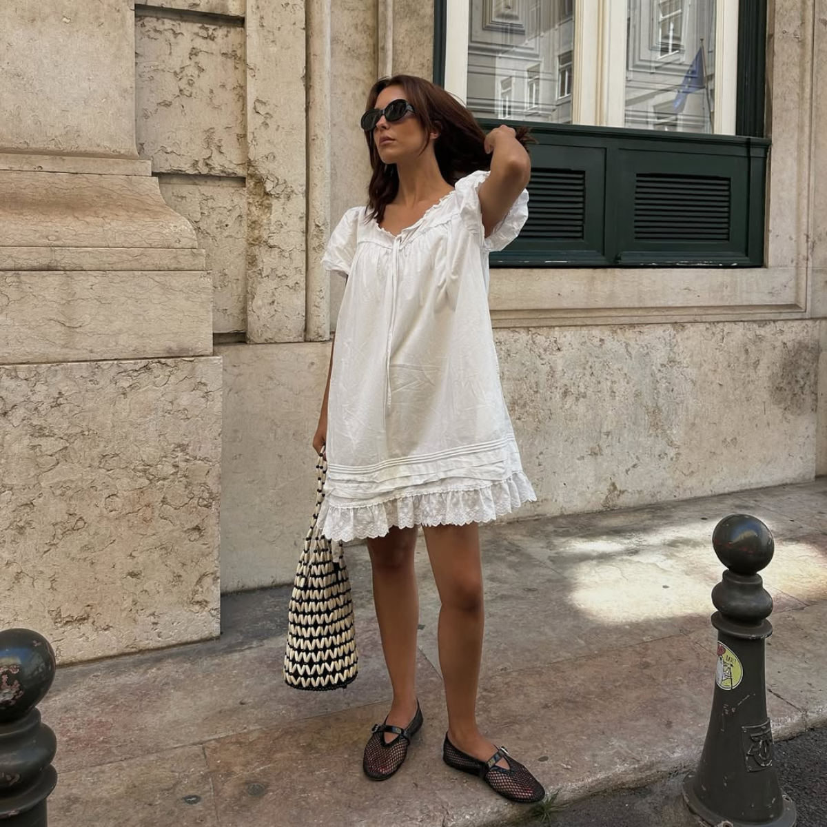Debora in white mini dress and mesh black ballet flats