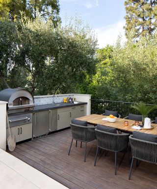 decked terrace with outdoor kitchen and dining area in Los Angeles