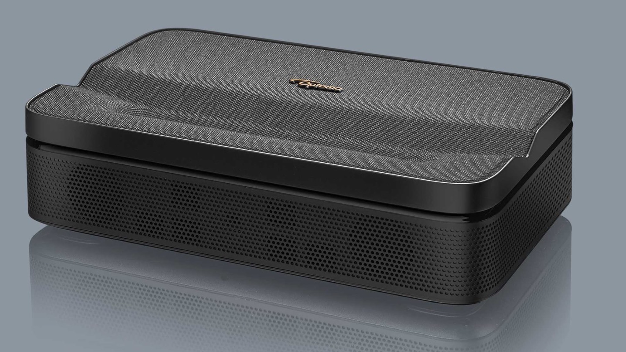 A product photo of the Optoma Photon Go projector on a grey surface against a grey background