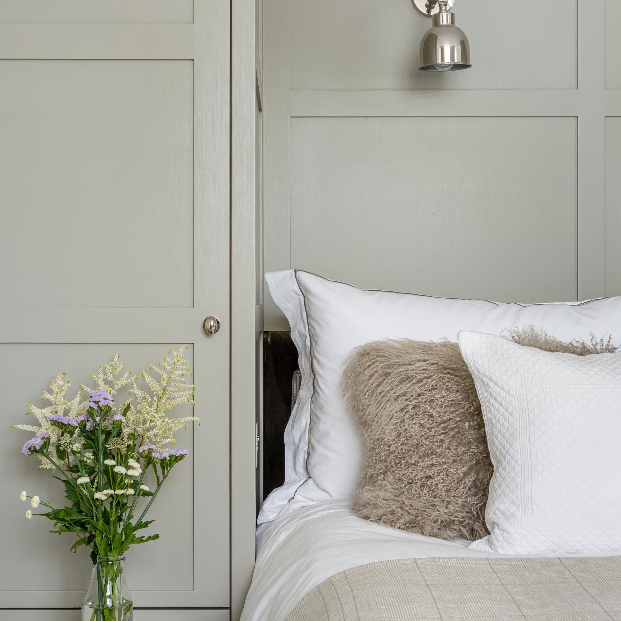 Bedroom with built-in wardrobe around bed - credit Lara Clarke Interiors