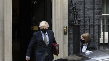 Boris Johnson leaves Downing Street wearing a face mask to attend Prime Ministers' Questions