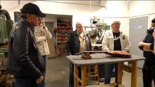 Joe Bonamassa, Tom Murphy and others examine a fake Les Paul