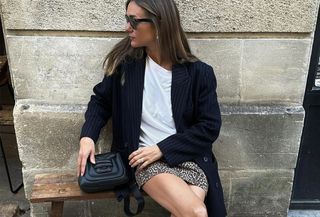 French woman in leopard-print miniskirt, T-shirt, and blazer.