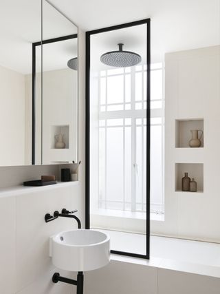 A small bathroom with shower and bath in one