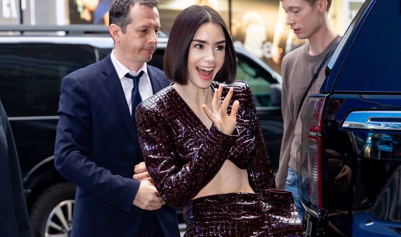 Lily Collins in a burgundy reptile print set 