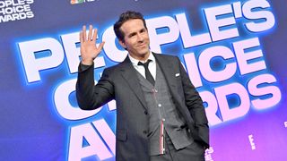 Ryan Reynolds waves to photographers at on People's Choice Awards red carpet