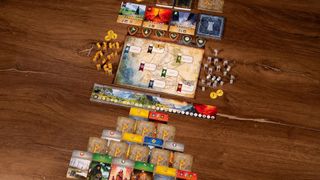 The board, cards, and tokens of Duel for Middle-earth laid out on a table