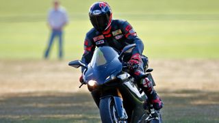 Prince William departs, riding his Ducati 1198S motorbike, after playing in the Westbury Shield charity polo match