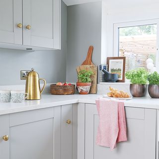 grey kitchen with white worktops